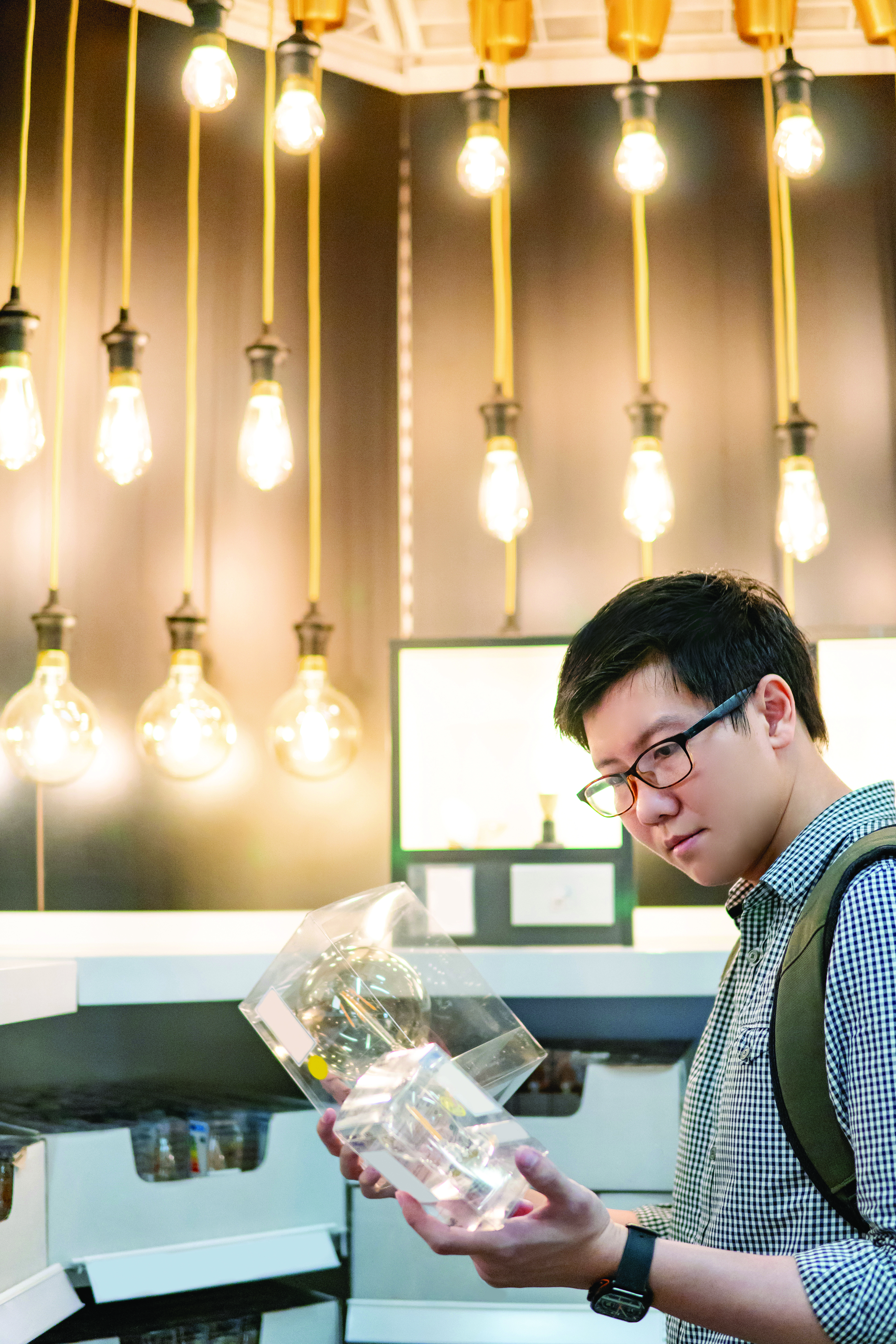 Stock photo of young man choosing package in store.
